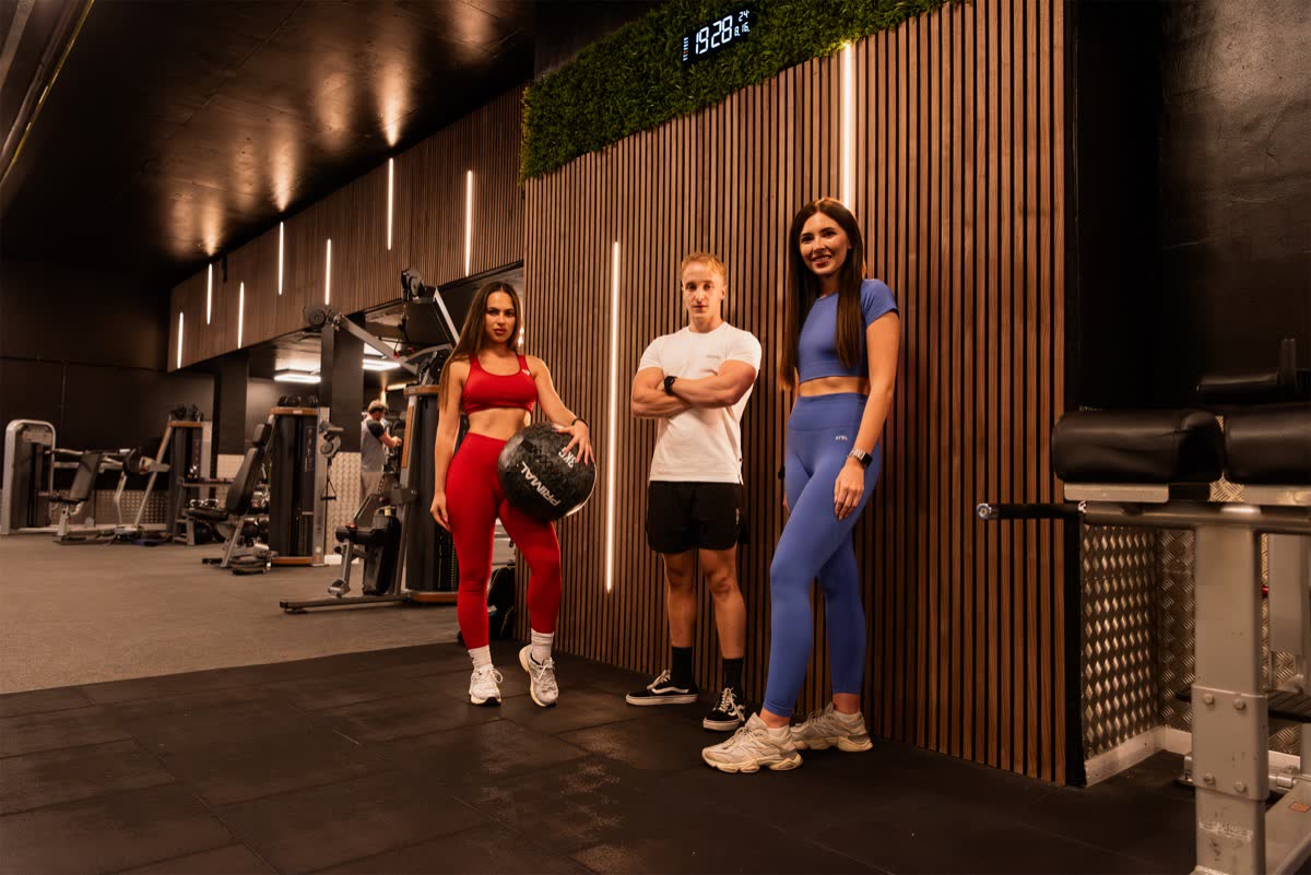 Three members together on the gym floor