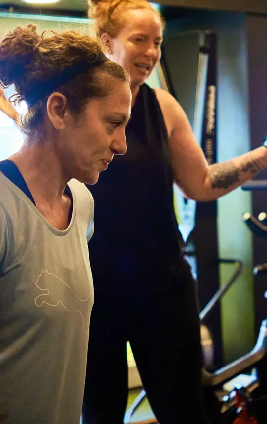 Coach guiding a member through an exercise on the training floor at Avoya Fitness Bromley