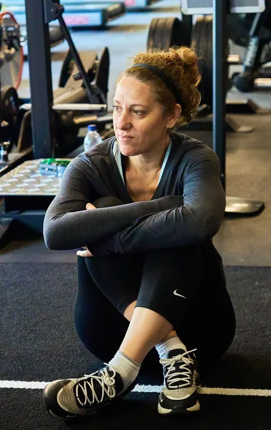 Member taking five on the gym floor during a group session