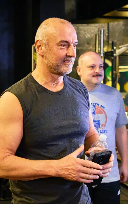 Member sharing a laugh between sets on the strength floor