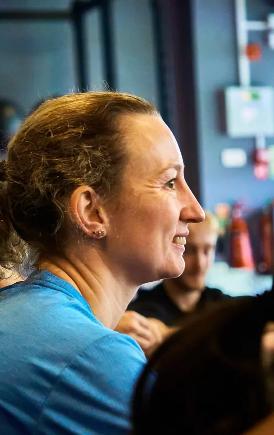 Member all smiles during a group huddle at Avoya Fitness Bromley