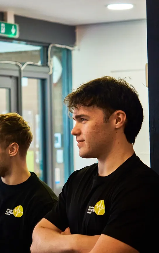 Two members catching up by the front windows after a session