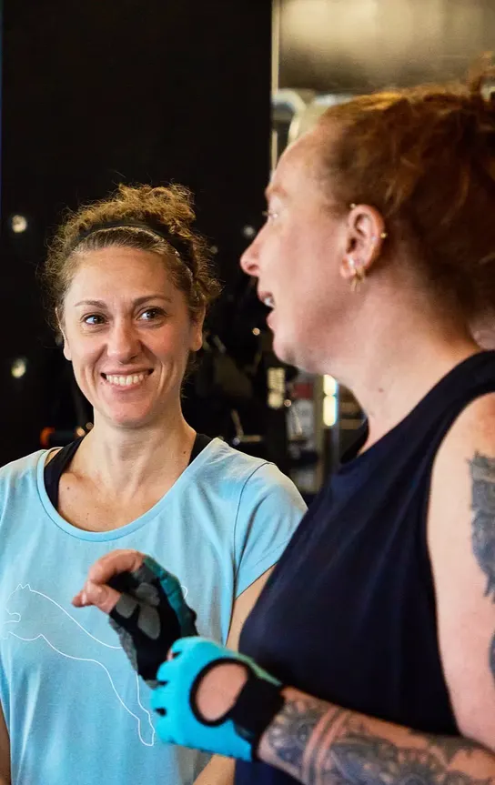 Two members sharing a laugh together mid-session on the training floor