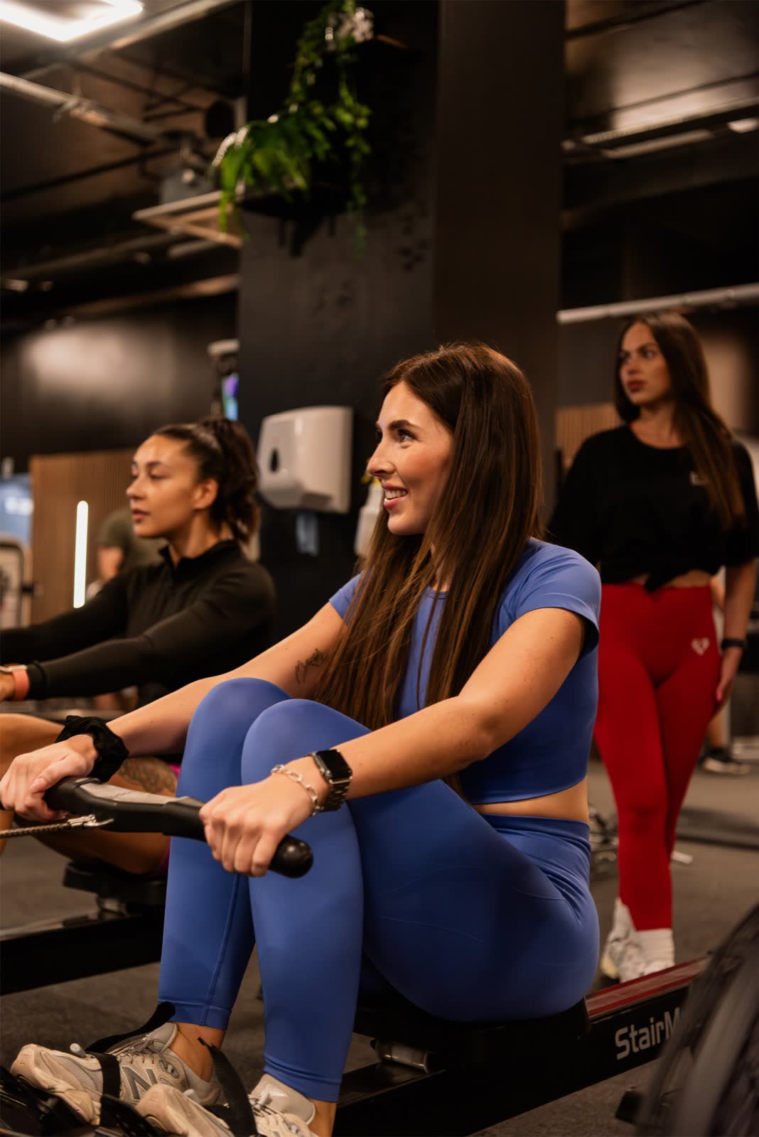 Members on rowing machines training together