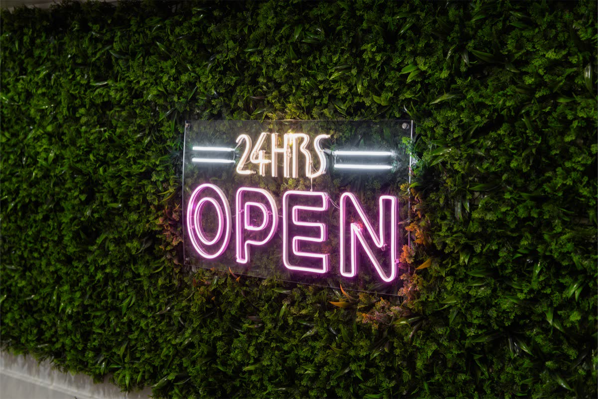 24 hours open sign set into the living plant wall